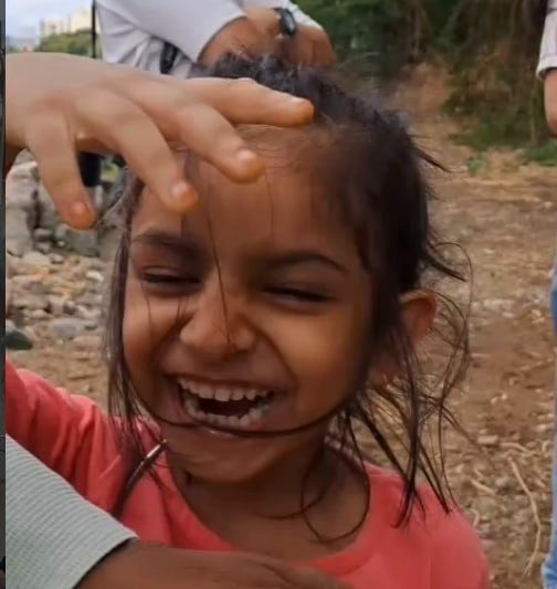 A child laughing while spinning the ring