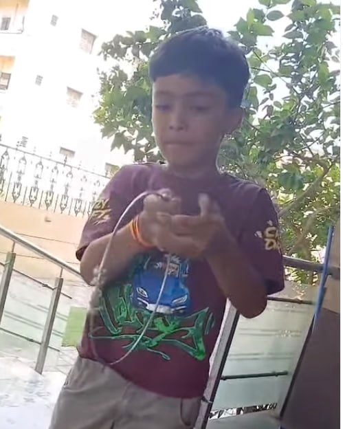 A boy holding up the ring
